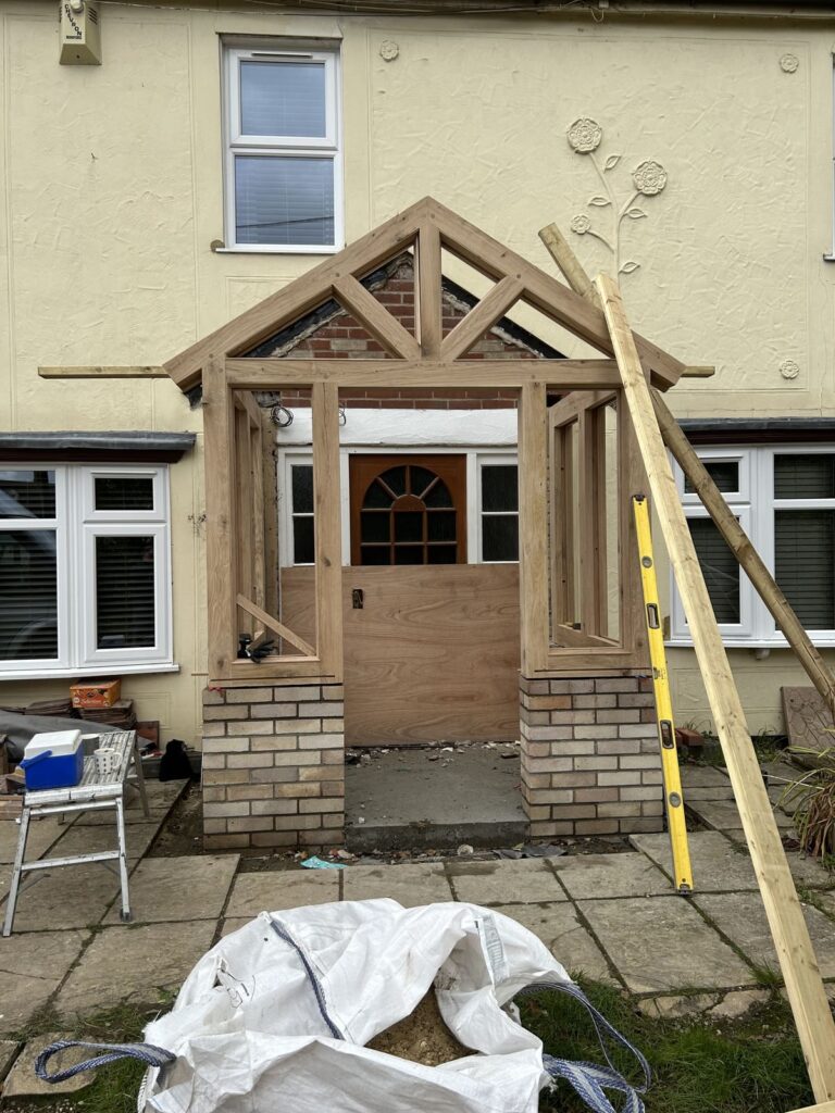 Work in progress image of the front view of an oak porch